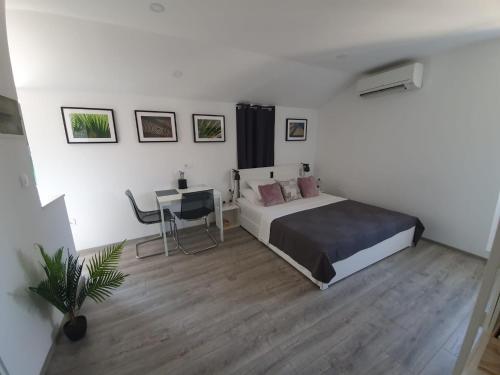 a bedroom with a bed and a table in it at Slatki kut in Vis