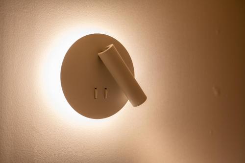 a lightswitch on a wall with a light on it at Hithere City Myeongdong in Seoul