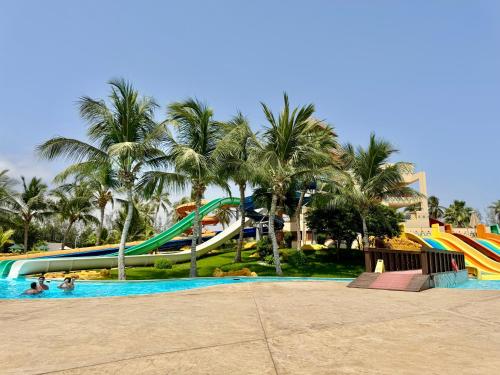 a water park with slides and palm trees at Lux Villa Azure in Salalah