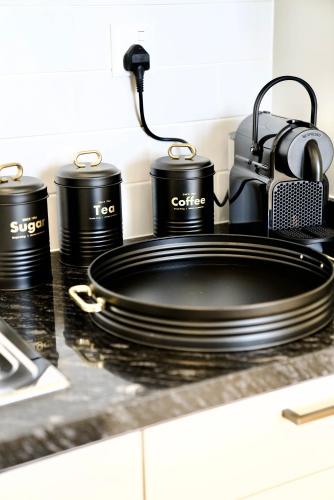 a stove with pots and pans on a counter at Lux Villa Azure in Salalah