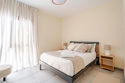 a bedroom with a bed and a large window at Chalet de lujo en Cala Lanuza con vistas al mar in El Campello