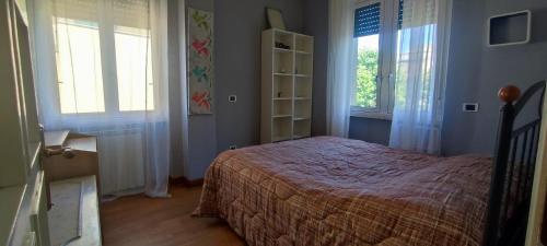 En eller flere senge i et værelse på Ostia Fronte Mare - Bibbi's Seaview Flat