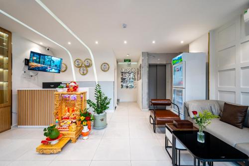 a living room with a couch and a tv at A Boi Apartment at District 3 in Ho Chi Minh City