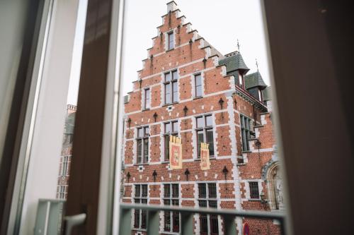a view of a large brick building from a window at Vakantiewoning De Curiositeit in Geraardsbergen
