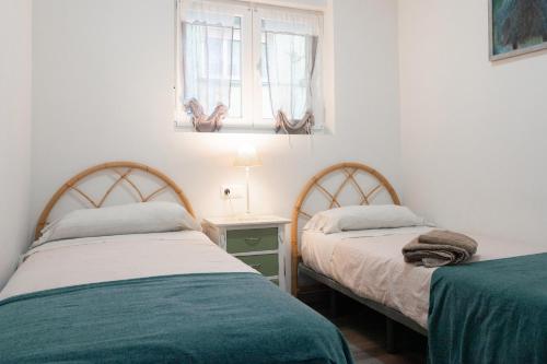 Ένα ή περισσότερα κρεβάτια σε δωμάτιο στο Apartamento Puertu Chicu