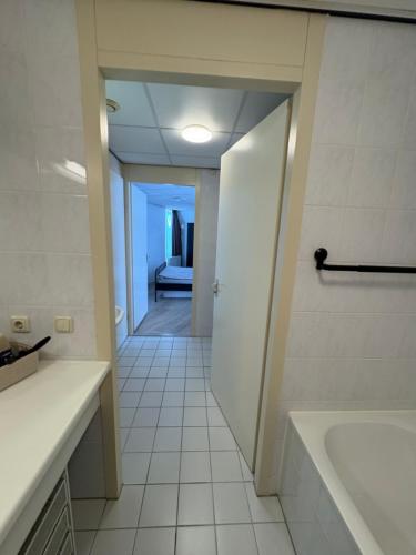 a bathroom with a tub and a sink and a toilet at Appartament ,,Marti strand Makkum'' in Makkum