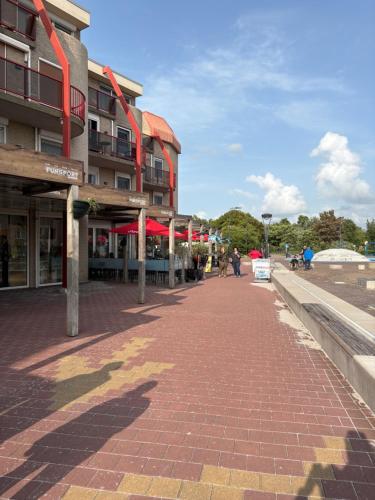 a brick sidewalk in front of a building at Appartament ,,Marti strand Makkum'' in Makkum