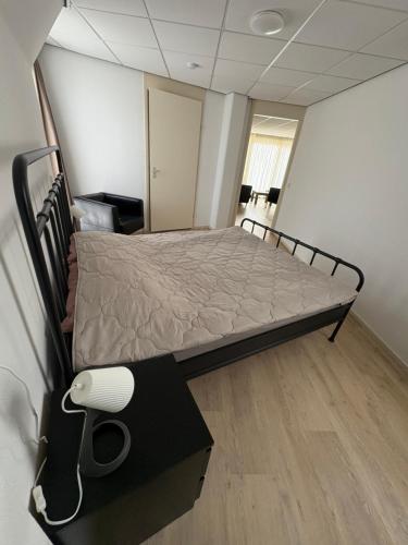 a bedroom with a bed in a room with at Appartament ,,Marti strand Makkum'' in Makkum