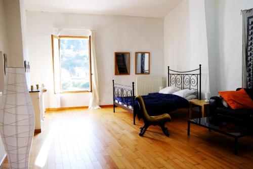 a bedroom with two beds and a window at Le loft de Saint-Laurent in Saint-Laurent-le-Minier