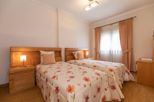 a bedroom with two beds and a window at Anadia Penthouse Duplex by Rent-a-key in Funchal