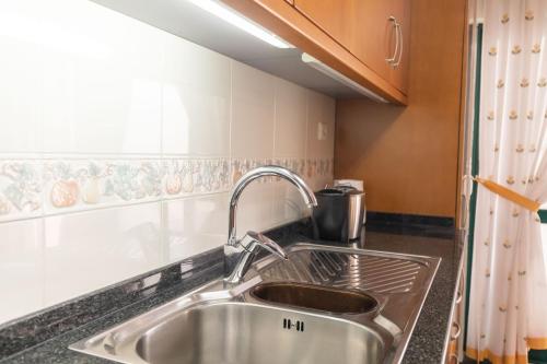 a kitchen counter with a sink and a window at Anadia Penthouse Duplex by Rent-a-key in Funchal