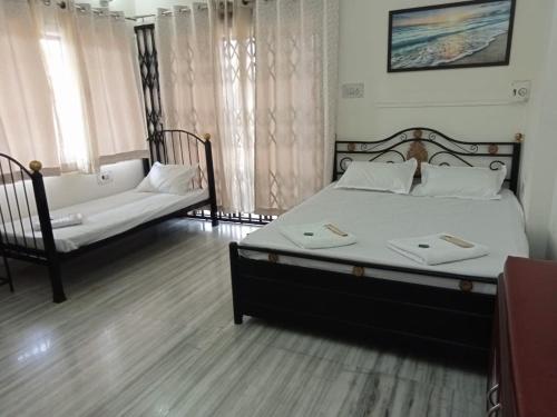 a bedroom with a large bed and a couch at Villa De Quads in Lonavala