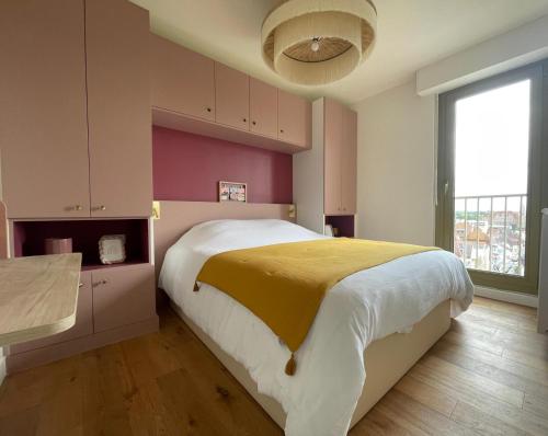 une chambre avec un grand lit et une grande fenêtre dans l'établissement Bel appartement cosy, superbe vue mer ! pour 6 personnes, à Le Touquet-Paris-Plage