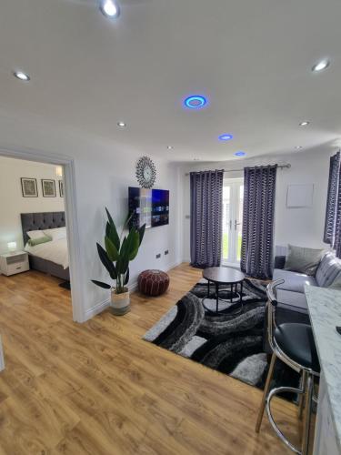 a living room with a couch and a table at Very Cosy & Lovely 1 Bed Garden Apartment with side access, Suitable for Long Stay and Short Stay in Slades Green