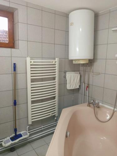 a bathroom with a bath tub and a sink at Apartmani Milica in Kraljevo