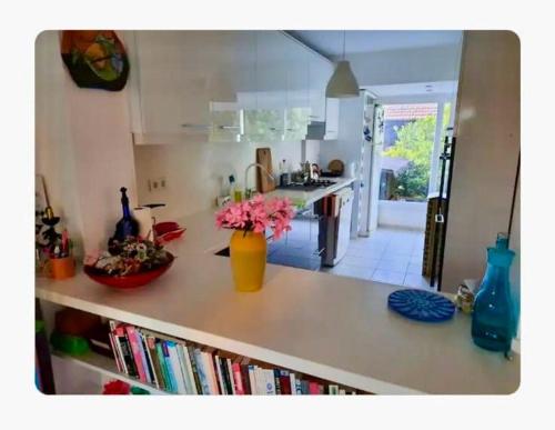 a kitchen with a counter with a vase of flowers on it at Seferihisar İz Tur sitesinde özel plajlı villa in Seferihisar