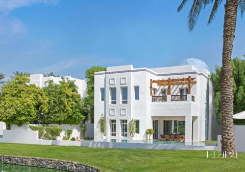 a rendering of a white house with a palm tree at Elara & Golf Villas - curated by Park Hyatt Dubai in Dubai