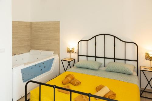 Postel nebo postele na pokoji v ubytování Maris Suite - Appartamento con vasca idromassaggio