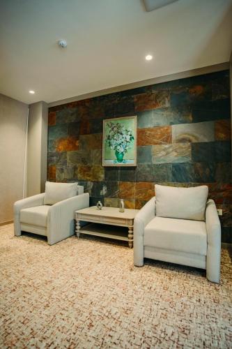 two couches and a coffee table in a living room at Hill Chalet Hotel Gabala in Gabala