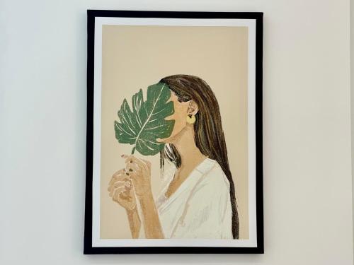 a drawing of a woman holding a leaf at Modern Two-Bedroom Flat in Swindon