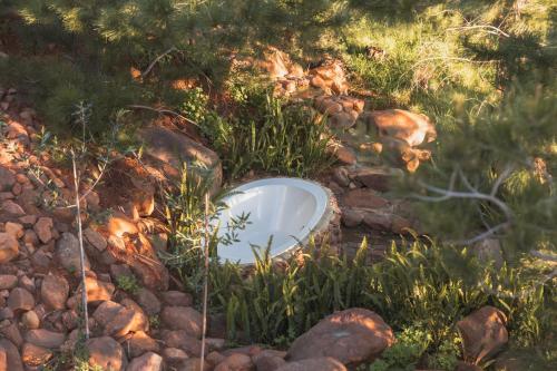 a bowl sitting on a pile of rocks at Cape Robin Cabin at Vrolikheid Landgoed in Tulbagh