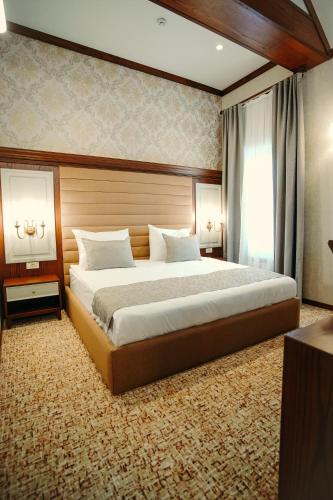 a bedroom with a large bed in a room at Hill Chalet Hotel Gabala in Gabala