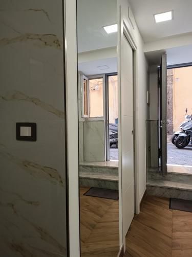 a hallway with a glass door with a mirror at L'Approdo di Dante in Naples