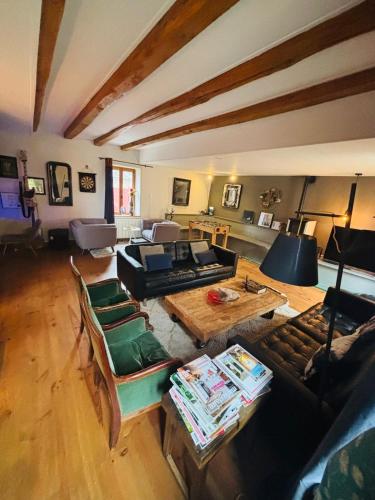 a living room with a couch and a table at L'ancienne Epicerie de POIL in Poil