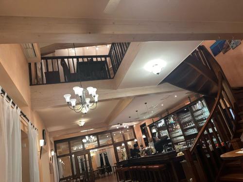 a restaurant with a staircase and a chandelier at Hotel Grado in Ransbach-Baumbach