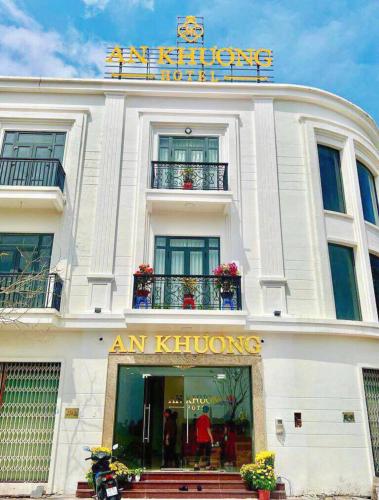 a white building with a sign on top of it at Hotel AN KHƯƠNG in Rach Gia