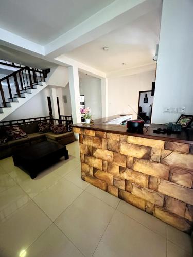 a kitchen and living room with a wooden counter top at Ranaya Residence Kandy in Kandy