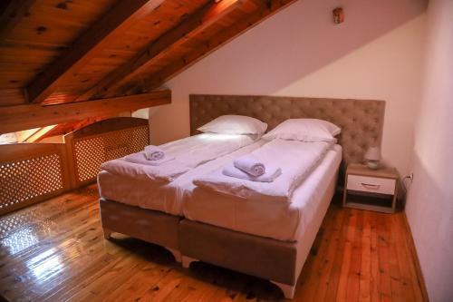a bedroom with a large bed in a attic at Careva Cuprija Apartment&Rooms in Sarajevo