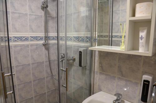 a bathroom with a shower and a sink at Careva Cuprija Apartment&Rooms in Sarajevo