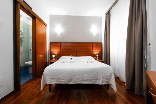 Postel nebo postele na pokoji v ubytování Hotel City Center