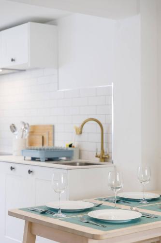 a kitchen with two wine glasses on a table at Central quiet cottage Walk to shops, bars & beach in Brighton & Hove