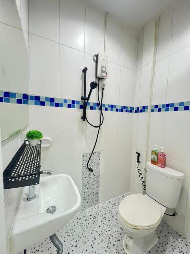 a bathroom with a toilet and a sink at La Locanda in Bangkok