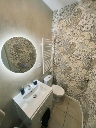 une salle de bain avec un lavabo, des toilettes et un miroir dans l'établissement Apartment t3, 50m2, downtown, à Istres