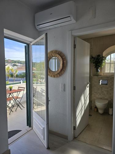 a hallway with a door leading to a balcony at Sesimbra Stylish Villa by Homing in Sesimbra