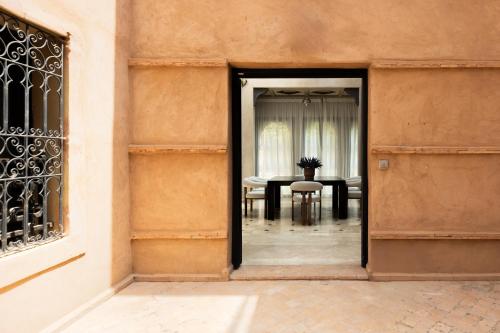 an open door into a dining room with a table at Marrakech Villa with Private Pool & Family-Friendly in Marrakesh