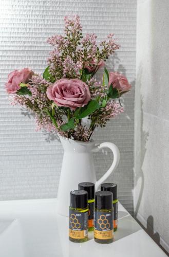a white vase with a bouquet of flowers in it at Villa Antoni in Galatás