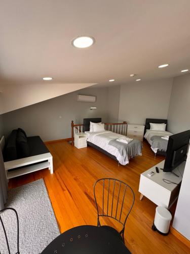 a room with two beds and a desk and a television at İstanbul Guesthouse in Istanbul