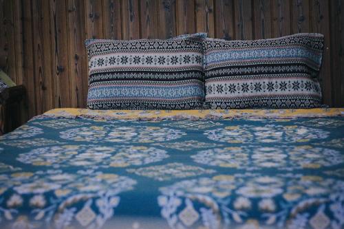 a bed with two pillows on top of it at Peaceful Hill Homestay in Ke Ga