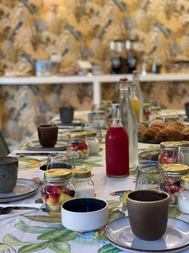 a table with plates of food and a bottle of sauce at Le Camere Pietrasantine - Centro Storico in Pietrasanta