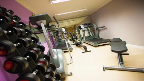 a gym with a bunch of tread machines at Best Western Plus Lancashire Manor Hotel in Skelmersdale