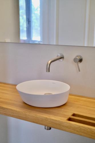 a white sink on a wooden counter in a bathroom at Vigla Paxos in Lákka