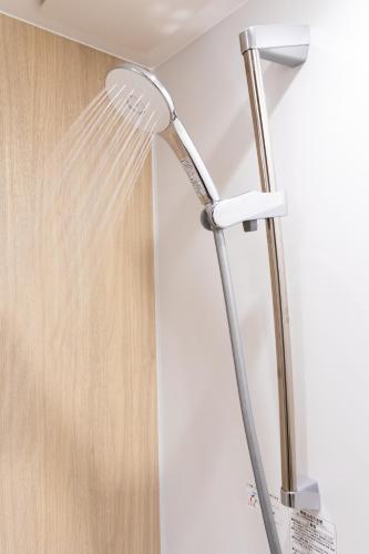 a shower head in the corner of a bathroom at Ueno-an 4,5F in Tokyo