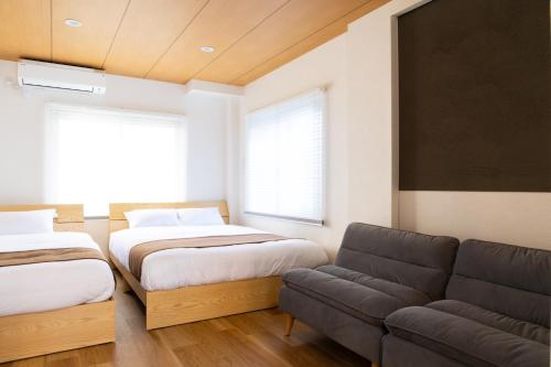 a living room with two beds and a couch at Ueno-an 4,5F in Tokyo
