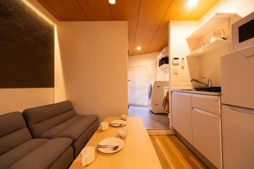 a living room with a couch and a table at Ueno-an 4,5F in Tokyo