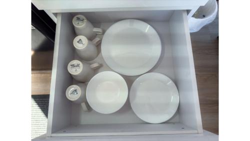 a box filled with white plates and vases at Hill River Nature Reserve by Tiny Away in Jurien Bay