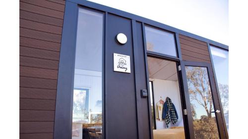 a building with a door with a sign on it at Hill River Nature Reserve by Tiny Away in Jurien Bay